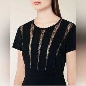 Black Max Mara black short-sleeved peplum top with lace inserts.